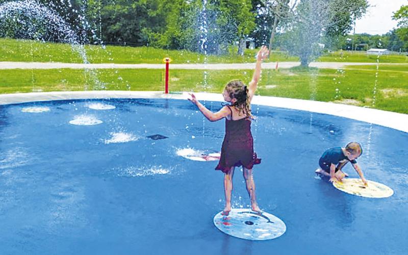 The Splash Pad at Kosse City Park is officially up and running, providing plenty of free, splashing fun for kids of all ages! Pictured are Paisley and Parker Brouillette, enjoying the spray of cool water as the Texas summer heat sets in.  Alexandra Cannon photo/Groesbeck Journal