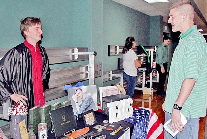 Homeschool graduate Jared Ottinger, left, of Thornton, mans his table as he chats with pal Mason Foulis, of Mexia, at the reception following the Homeschool Graduation ceremony. The event was held at First Baptist Church, Fairfield on Sunday, June 6. Two Thornton homeschoolers graduate