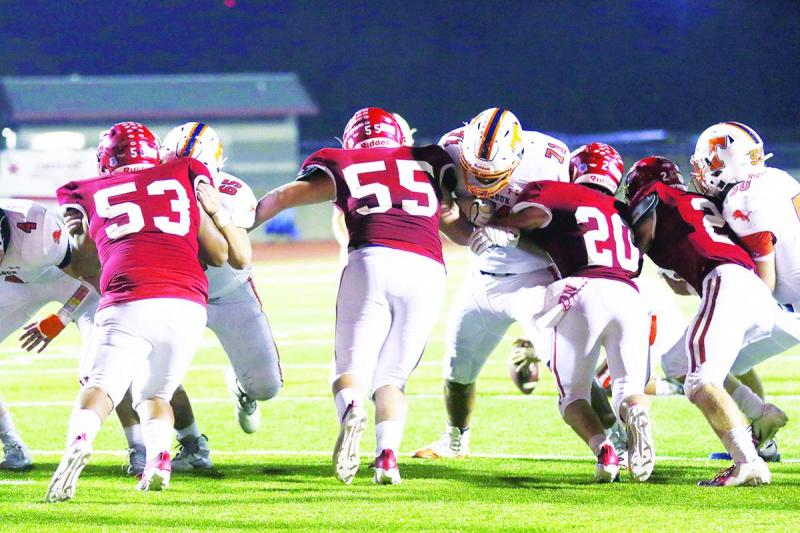 Groesbeck defenders battling with Teague at the line of scrimmage include Ethan Gonzalez (53), Colby Weihausen (55), Brian Valentine (20) and Coker Holloway (2). The Goats outscored Teague 51-41 to clinch their first playoff berth in three years. Photo by Angela Crane/For the Groesbeck Journal Article Image Alt Text