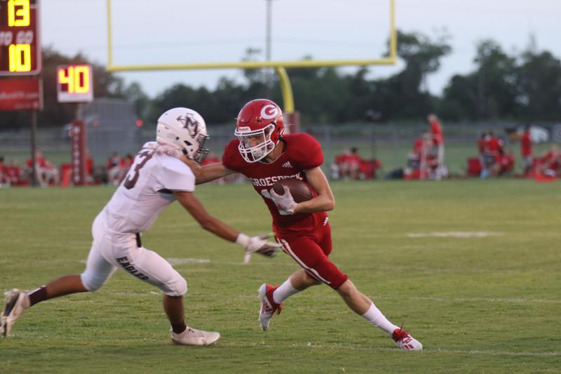 #12 Tyson Pringle pushing through the Eagles. Angela Crane Goats take Mildred, 53-6.