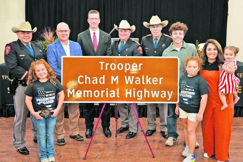 (in no particular order) Major Ruben Galindo; Texas State Rep. Kyle Kacal; Central Texas Regional director, Todd Snyder; Deputy Director, Freeman Martin; Texas DPS Director, Steven McCraw; and the family of the late Trooper Chad Walker; his wife, Tobie; son, Ethan; twin daughters, Rylee and Charlee; and Tulsa June with the newly dedicated Highway Memorial sign in honor of Trooper Walker on Tuesday, Nov. 8.