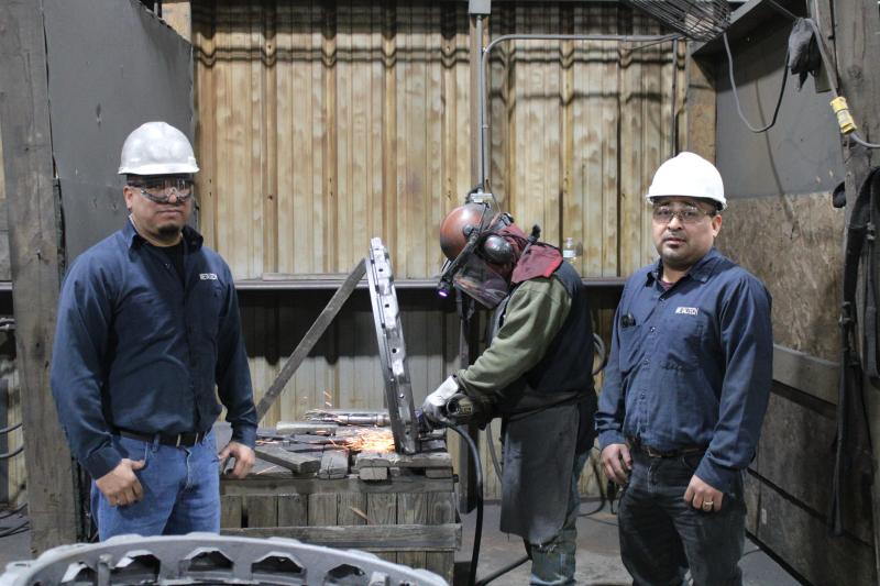 Guadalupe Damian and Juan Ramirez pose with an employee grinding away. Article Image Alt Text