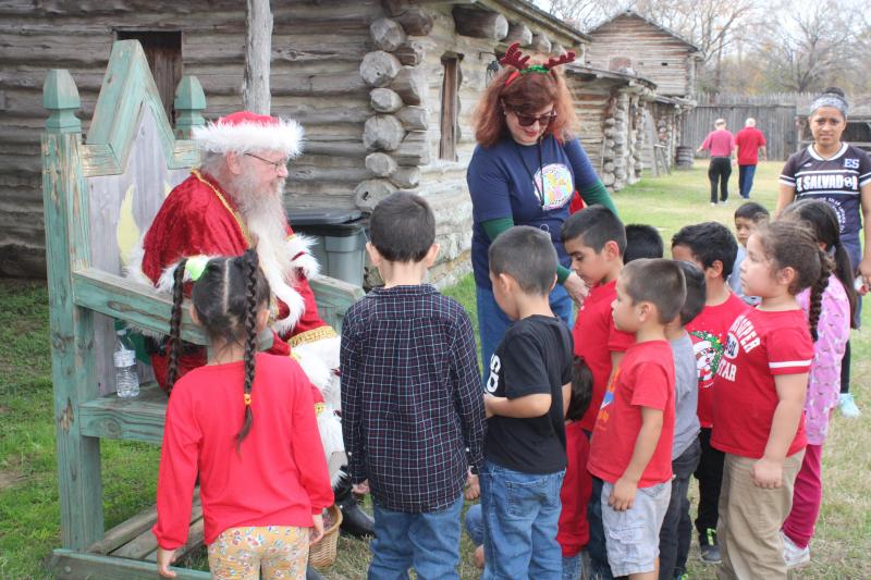  Christmas at the Fort is an opportunity for kids and adults alike to experience the unique historical significance of Old Fort Parker along with the joy of Christmas! This picture, from last year’s festivities, shows elementary students inside the old fort replica visiting with Santa Claus, who will be making a repeat appearance this weekend for Christmas at the Fort, Thurs. Dec. 7-Sunday Dec. 10.