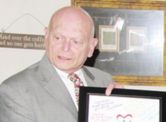 Judge P.K. Reiter, is presented a framed poster with signatures and notes of thanks from Voices for Children/CASA personnel at a small reception for Reiter held at Coffee Cabaret in Mexia in September 2019. Judge Reiter worked until his passing away on Tu Respected, longtime judge P.K. Reiter passes