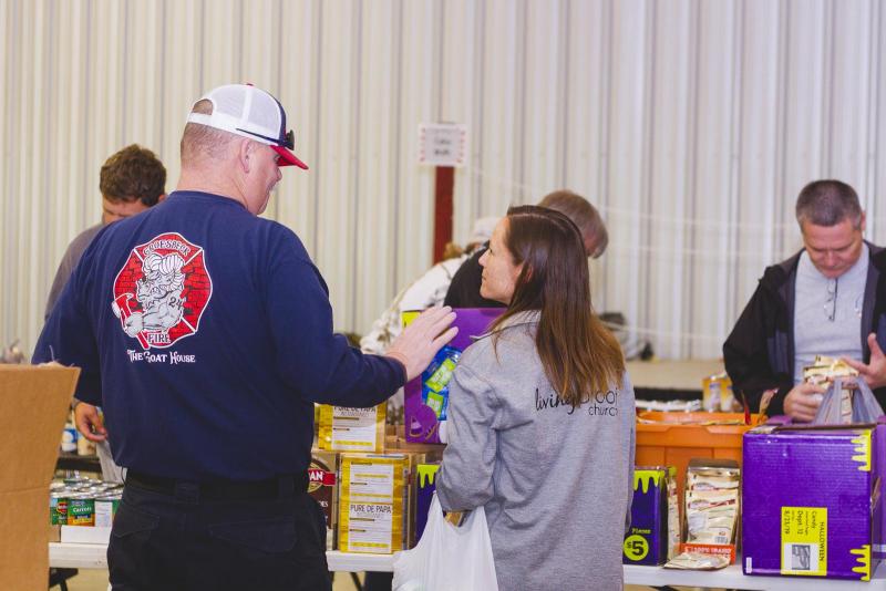 Church members and volunteers sort food to be delivered to families in need for full Thanksgiving feasts sponsored by the Living Proof Church for the last eleven years. Article Image Alt Text