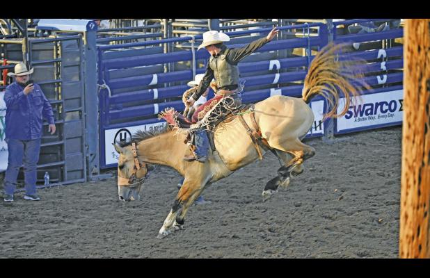 Tripp Burleson, who will be a senior at Groesbeck High School, competes in the saddle bronc riding competition at the 96th Annual Mexia Rodeo on Thursday night, June 25. Photo by Mitchell Pate/Groesbeck Journal