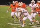 ABOVE: Wayland Allison tackles a Kemp ball carrier as Jarrett Bodine and Henry Cordona comes in to assist. Yellowjackets sting Lions in district opener 48-34