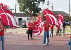 The GHS color guard spins their flags for fans during Friday’s downtown pep rally. The GHS color guard spins their flags for fans during Friday’s downtown pep rally.