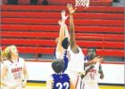 Sophomore Tyson Pringle goes for the hoop as Ca’Zain Bradley watches in anticipation. Competitive play led to overtime for the Goats that proved victorious after overtime play.