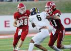 ABOVE: Groesbeck’s Brenden Morrow (28) runs with the ball as teammate Zach Ellison (11) blocks Malakoff’s Davion Tolliver (6) during a game at Groesbeck on Thursday night. State-ranked Malakoff swarms past Groesbeck, 35-0