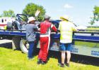 Event Organizer Mike Satterfield (left) and Motorsport Director Richard Tomlin (right) offered words of consolation and support for driver James R. Smith after his Lotus Super 7 took on major damage in a wreck at the Groesbeck Grand Prix on Sunday, Septem Revved Up