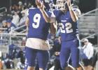 LEFT: Wortham’s Brandon Coker (9) and Riley Baker (22) celebrate a touchdown to end the first half of a District 11-2A, Division II football game at Wortham. Coker passed nine yards to Baker with no time left in the first half to help the Bulldogs to a Bulldogs maul Frost 36-23 in district opener