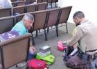 Limestone County Sheriff Murray Agnew and Limestone County Deputy Allan Stewart help pack backpacks for local students at Living Proof Church on July 31. Article Image Alt Text