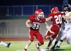 ABOVE: Groesbeck’s Chris Cox (25) runs with the ball as teammate Brian Valentine (20) throws a block during a game against Malakoff on Thursday night. State-ranked Malakoff swarms past Groesbeck, 35-0