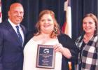 Citizen of the Year - Brandi Getz Pictured from left to right are Chris Henson, Brandi Getz and Valerie Henson. The Hensons presented the Citizen of the Year award to Getz, after highlighting a high commitment to organizations, Groesbeck ISD and residents