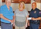 Lions Club President Kara McLelland is shown presenting an $800.00 check to Chief of Police Chris Henson with Tom Hawkins, a Chamber director, also pictured. The donation will be used to purchase new radios for the Groesbeck Police Department. Article Image Alt Text