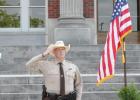 Limestone County Sheriff’s Office Patrol Sgt. Lee Cox looks up to the heavens during the playing of the national anthem at the beginning of the Peace Officers Memorial, held Friday on the steps of the courthouse. Article Image Alt Text