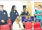 (pictured below) (l to r) Ryder Bagley, Winni Lin and Whitney Lehrman showed off the banner they won at FFA State Competition, where they placed 6th, while their FFA Sponsor Jenna Jones (far right) bragged on the accomplishments and hard work of the team. Determined 8th graders snag sixth-place at state competition