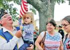 Russ Foster, of American Legion Ashburn-Hannah Post 288, and his family relax after the Veterans Day ceremony at the Limestone County courthouse on Monday, Nov. 11. Russ holds granddaughter Evie Mills, 2, while his wife, Mary, and their daughter, April Mi Limestone honors veterans with parade 100th birthday for WWII vet and American Legion