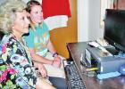 Dr. Sunny Kelly, at rear, head of Limestone Medical Center’s Speech and Physical Therapy Department, sits briefly with speech therapy pathologist Linda Anders, who is illustrating how she uses a computer program to conduct speech therapy on Parkinson’ LMC proud to be Big and Loud