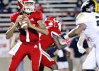 ABOVE: Groesbeck quarterback Allen Lewis looks to pass the ball against Malakoff in a district game at Groesbeck Stadium on Thursday night. State-ranked Malakoff swarms past Groesbeck, 35-0
