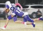 ABOVE: Wortham defensive back Ryken Lewis (12) tackles Frost receiver Korben Bowling during a game Friday night. Lewis had an interception which led to Wortham’s first touchdown in a 36-23 victory. Bulldogs maul Frost 36-23 in district opener