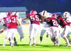 Groesbeck defenders battling with Teague at the line of scrimmage include Ethan Gonzalez (53), Colby Weihausen (55), Brian Valentine (20) and Coker Holloway (2). The Goats outscored Teague 51-41 to clinch their first playoff berth in three years. Photo by Angela Crane/For the Groesbeck Journal Article Image Alt Text