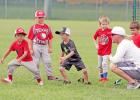 Groesbeck head baseball coach Cameron Sellstrom, right, gives the “go” as a couple of youngsters take off during base running drills at the Teach Me More baseball camp held last week at the high school field. Photo by Stephen R. Farris/Journal Sports