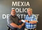 Mexia Police Chief Heath Crossland accepts the donation check for SRO Training from Limestone County Crime Stoppers Board Member Carl Haddick on Thursday, May 9. Article Image Alt Text