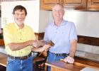 New Lions Club president Tom Levi is presented the president’s gavel by Shawn Harkin, the outgoing president. Journal Photo/Tom Hawkins