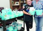 Enge-Washington Intermediate School fourth-grader Leighton Brooks holds one of the blue buckets she and other students are filling with treats and distributing to law enforcement officers they adopted. Brooks handmade bracelets to add to the buckets. Contributed Photo Article Image Alt Text