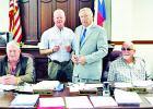 Photo by Roxanne Thompson/ Groesbeck Journal Limestone County Sheriff Dennis Wilson presents to County Judge Richard Duncan a donation he received for the Bullet-Proof Vest Fund, at commissioners court’s Aug. 14 meeting. Shown here, at center are Wilson Article Image Alt Text