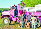 Members of the Lake Mexia Volunteer Fire Department are especially proud of their pink 5-ton fire truck. Shown here, standing from left, are Fire Chief Gene Parrish, standing at the door, Tammie Parrish, Heather Sterling, Billy Sterline, Paul Finley and Joshua Sterling, 11. At front is James Jaquay with the fire station’s dog Rescue, a black-mouthed cur. Photos by Roxanne Thompson/The Mexia News