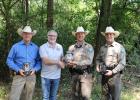 Capt. Jason Ash, of the Limestone County Sheriff’s Office Criminal Investigation Division, and Limestone County Crime Stoppers President Dean Satterfield present the new Spartan Eclipse Trail Cameras to Game Wardens Thomas Rinn and Dylan Wallace. Photo by Racheal Clark Article Image Alt Text