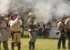 Confederate reenactors 'defend the fort' during a simulated surprise Union attack at the “Attack on Fort Parker” event. Article Image Alt Text