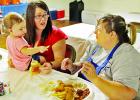 Brittney Jones, left, with her baby, Kyndall Jacobs, 10 months, visits with her relative Genia Bostian, of Mildred, at the Reagan Jacobs fish fry fundraiser, held Saturday, Sept. 9, at the Coolidge Community Center. Photos by Roxanne Thompson/The Groesbeck Journal