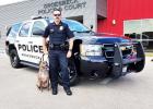Newest addition to the Groesbeck Police Department, K9 Opal proudly sits beside her handler Brad Martin in front of their squad car. Courtesy Photo