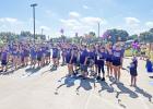 Participants gathered in unison to raise the pinwheel flowers they received at registration. The flowers were different colors to signify the role of the individual. Blue flowers meant the person was suffering from Alzheimer’s. Article Image Alt Text