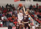 Groesbeck’s Allen Lewis (1) goes up for a shot as Fairfield’s Rex Beene (0) defends during a game at the Groesbeck High School gym Tuesday night. Fairfield nipped the Goats, 56-53.  Photo by Skip Leon/The Groesbeck Journal
