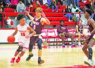 Groesbeck’s Anthony Lewis (20) drives past Fairfield’s Rex Beene (0) during a game at the Groesbeck High School gym Tuesday night. The Goats were edged by Fairfield, 56-53, in a key District 20-3A game.  Photo by Skip Leon/The Groesbeck Journal