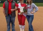 Parents Jason and Mica Trojacek pose with their daughter, Janae for a senior night picture after the game on Wednesday, March 20. Article Image Alt Text