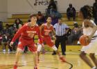 Groesbeck Goat basketball player Ty Hale (55) keeps his eyes on the ball handler during last week’s district game with the Marlin Bulldogs on the road. Helping out defensively from the wing is the Goats Randy Canady. Shannon Casto photo. Article Image Alt Text