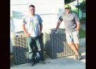 Cody Battreal (left), owner of Precision Air and John Palos (right), owner of Elite Air both donated free labor to install new air conditioning units at the Groesbeck Senior Center on Friday, June 22 after money was raised by generous individuals and organizations countywide. Groesbeck, Texas