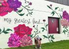 Tyler Kay, pictured here with her three-year-old Weimaraner, Shasta, painted this mural on the exterior of “Savage Finds” antique shop in downtown Waco last year. Groesbeck EDC Director TK Presley hopes the similar style work on Kay Contributed photo.